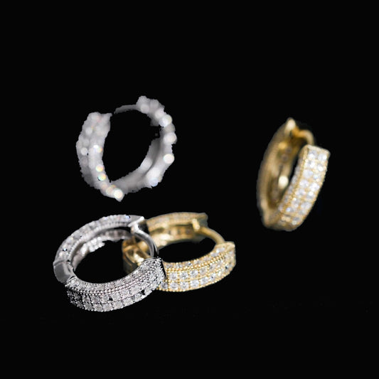 Apex moissanite hoop earrings in silver and gold on a black background