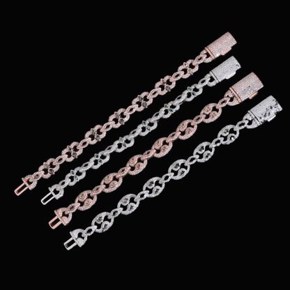 Bezel-Set Moissanite Cuban Link Bracelets arranged diagonally on black