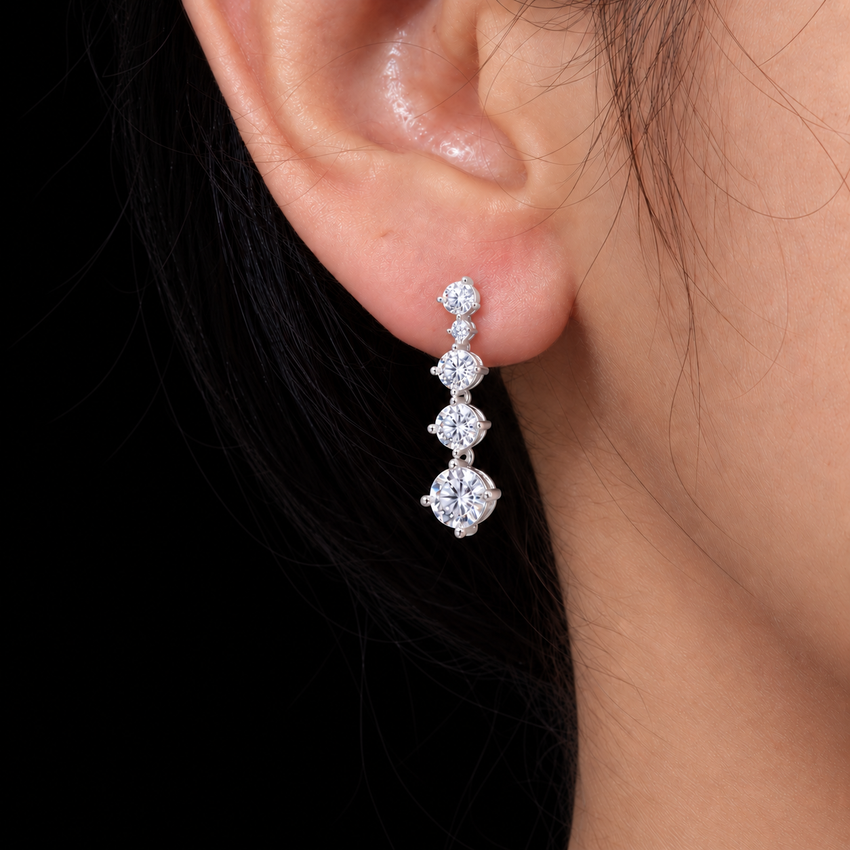 Cascade Moissanite Drop Earrings, Silver, 2 ct total, worn on ear against black background