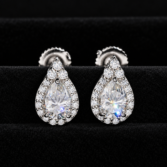 Pear halo moissanite stud earrings front view on black velvet