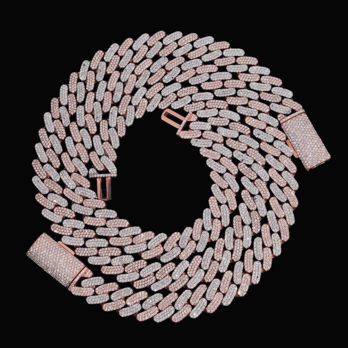 Two-tone 16mm moissanite Cuban link bracelet coiled on a black background