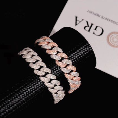Silver and two-tone 13mm moissanite Cuban link bracelets on black display