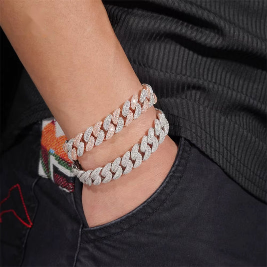 Two-tone 13mm moissanite Cuban link bracelet worn on wrist